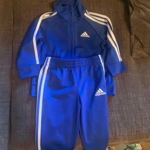 Blue and white stripped adidas shirt and pants